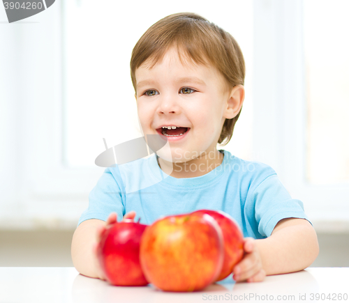 Image of Portrait of a happy little boy with apple