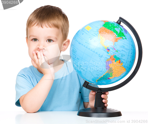 Image of Little boy with a globe