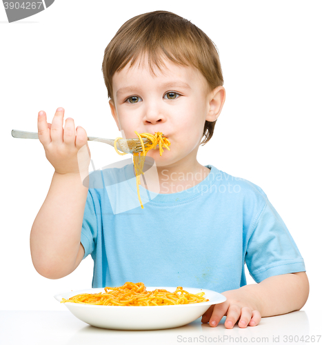 Image of Little boy is eating spaghetti