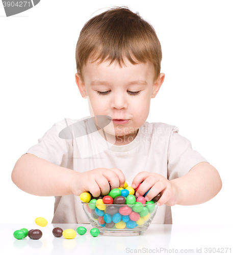 Image of Portrait of a boy with candies