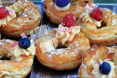 Image of cream puff with raspberries and blueberries