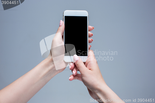 Image of Closeup shot of a woman typing on mobile phone 