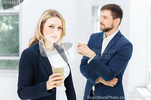 Image of Young colleagues having coffee break in office