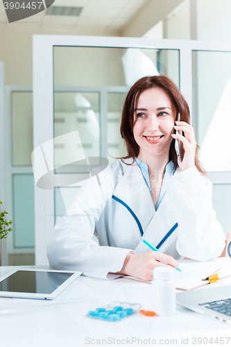 Image of Woman doctor sitting at the table