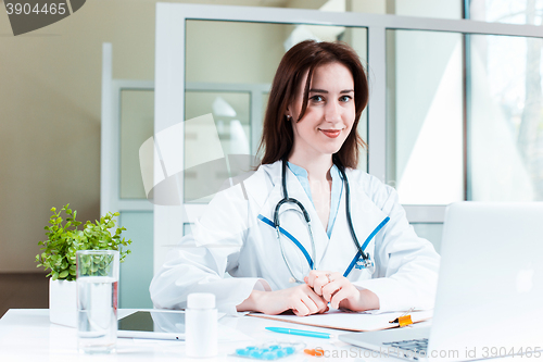 Image of Woman doctor sitting at the table