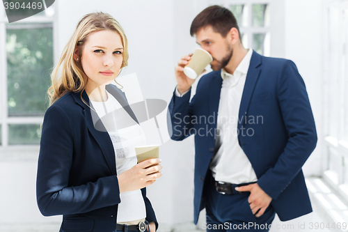 Image of Young colleagues having coffee break in office