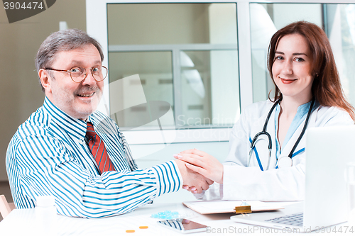 Image of The patient and his doctor in medical office