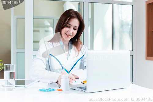 Image of Woman doctor sitting at the table