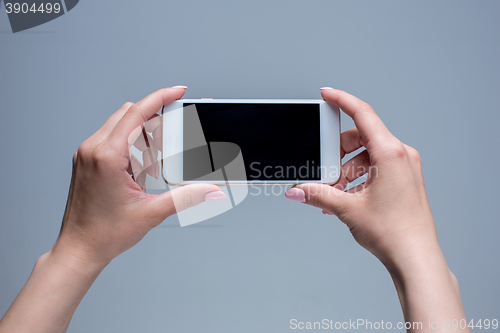 Image of Closeup shot of a woman typing on mobile phone 