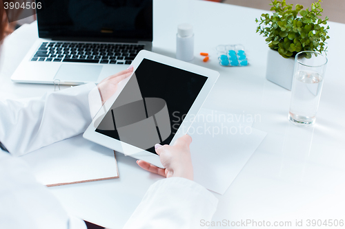 Image of Doctor working on a digital tablet