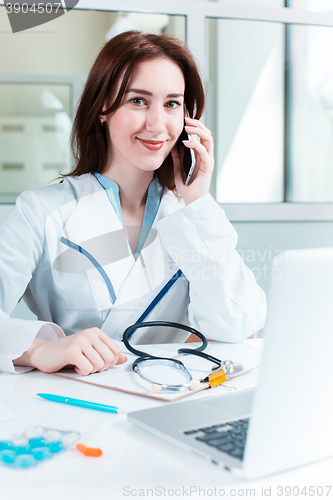 Image of Woman doctor sitting at the table