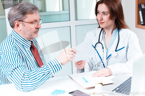Image of The patient and his doctor in medical office