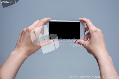 Image of Closeup shot of a woman typing on mobile phone 