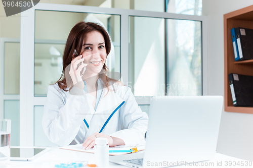 Image of Woman doctor sitting at the table