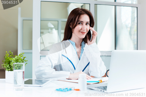 Image of Woman doctor sitting at the table