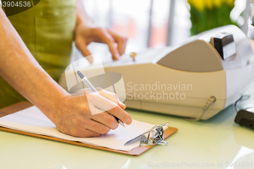 Image of close up of man with clipboard at flower shop