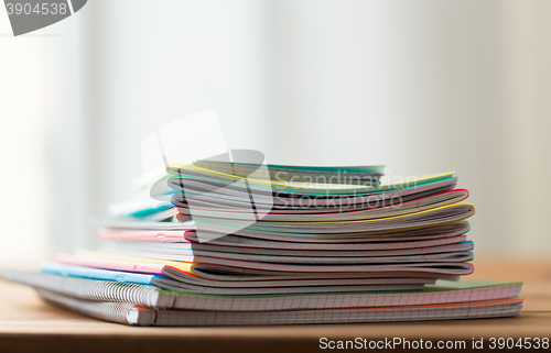 Image of close up of notebooks on wooden table