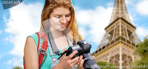 Image of woman with backpack and camera over eiffel tower