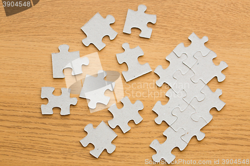 Image of close up of puzzle pieces on wooden surface