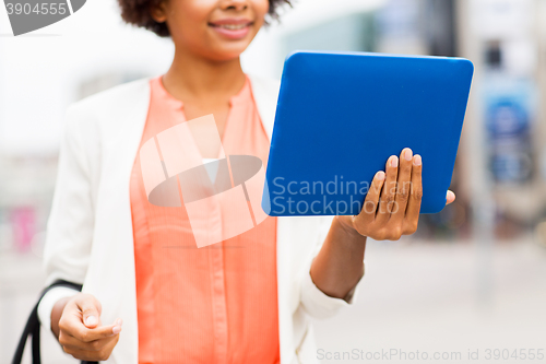 Image of close up of african woman with tablet pc in city