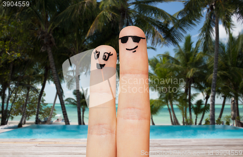 Image of close up of two fingers with smiley faces