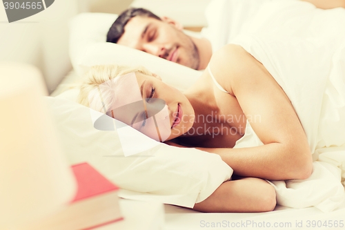 Image of happy couple sleeping in bed at home