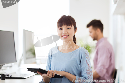 Image of happy creative female office worker with tablet pc