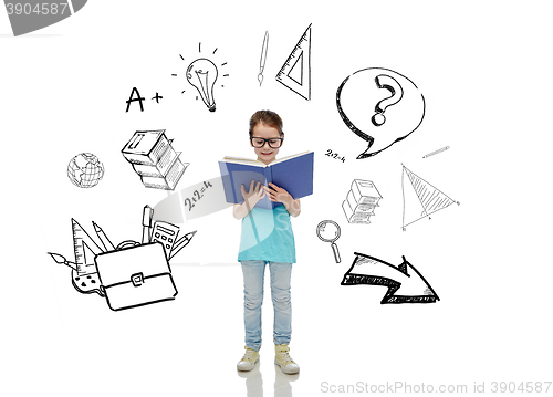 Image of happy little girl in eyeglasses reading book