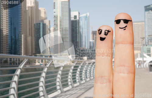 Image of close up of two fingers with smiley faces