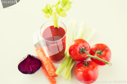 Image of close up of fresh juice and vegetables on table