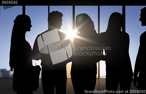Image of people silhouettes over office background