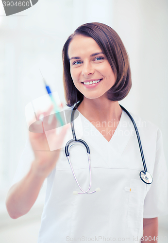 Image of female doctor holding syringe with injection