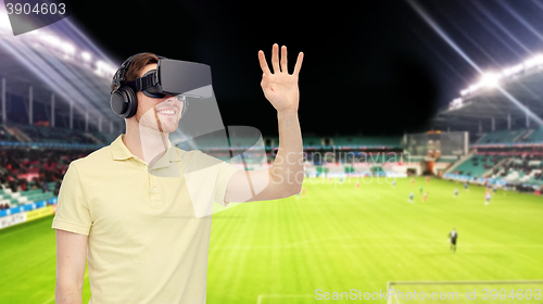 Image of man in virtual reality headset over football field