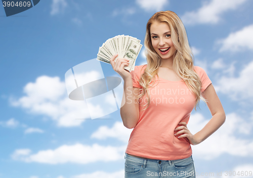 Image of happy young woman with usa dollar cash money