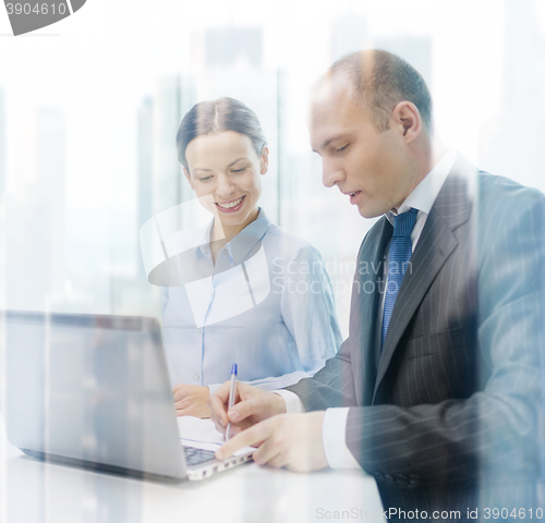 Image of business team with laptop having discussion