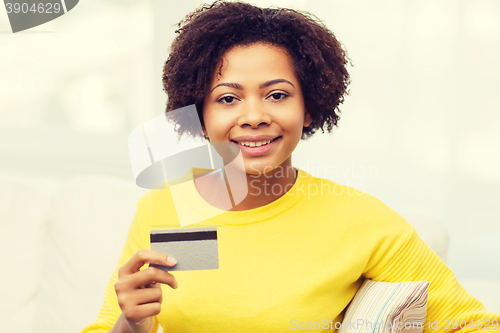 Image of happy african woman with credit or debit card