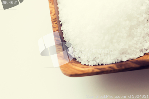 Image of close up of white salt heap in wooden bowl