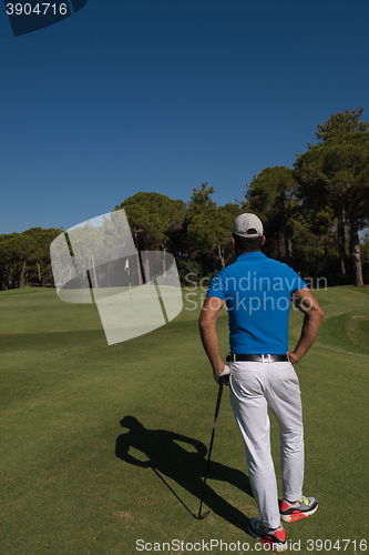 Image of golf player portrait from back