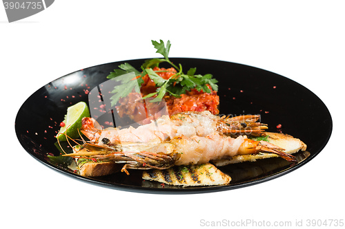 Image of perfect dish with shrimps on a black plate. seafood. Isolated  white background