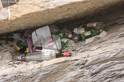 Image of Anapa, Russia - March 9, 2016: A pile of empty bottles in the niche of the rock