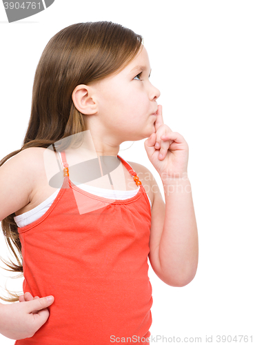 Image of Little girl is showing hush gesture