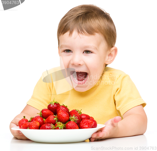 Image of Happy little boy with strawberries