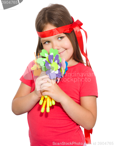 Image of Cute little girl wit a bunch of flowers