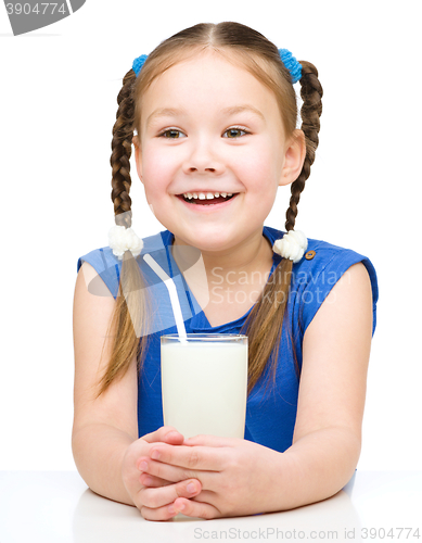 Image of Cute little girl with a glass of milk