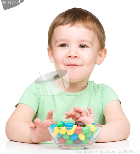 Image of Portrait of a boy with candies
