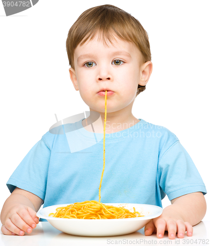 Image of Little boy is eating spaghetti