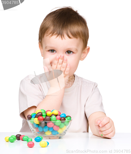 Image of Portrait of a boy with candies