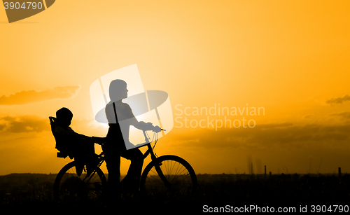 Image of Mother riding on a bicycle with her child