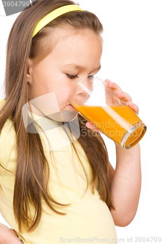 Image of Little girl is drinking orange juice