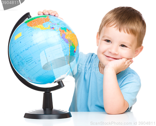 Image of Happy little boy with a globe